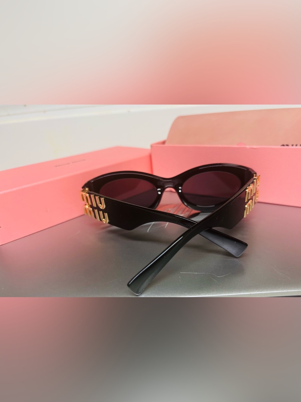 Miu Miu Black Oval Sunglasses with Gold Accent - Picture 4 of 7